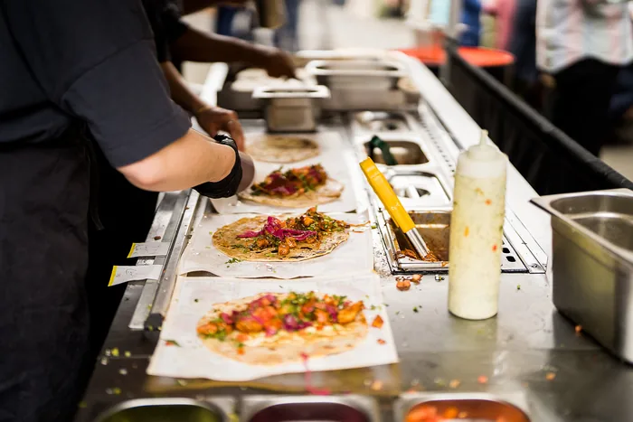 Street food trader plating up